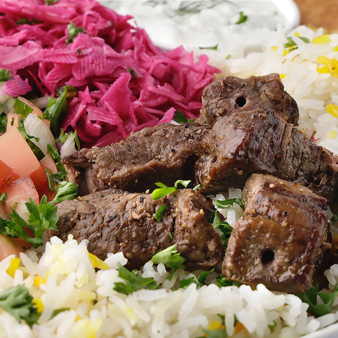 BEEF Kabab with rice and vegetables on a plate